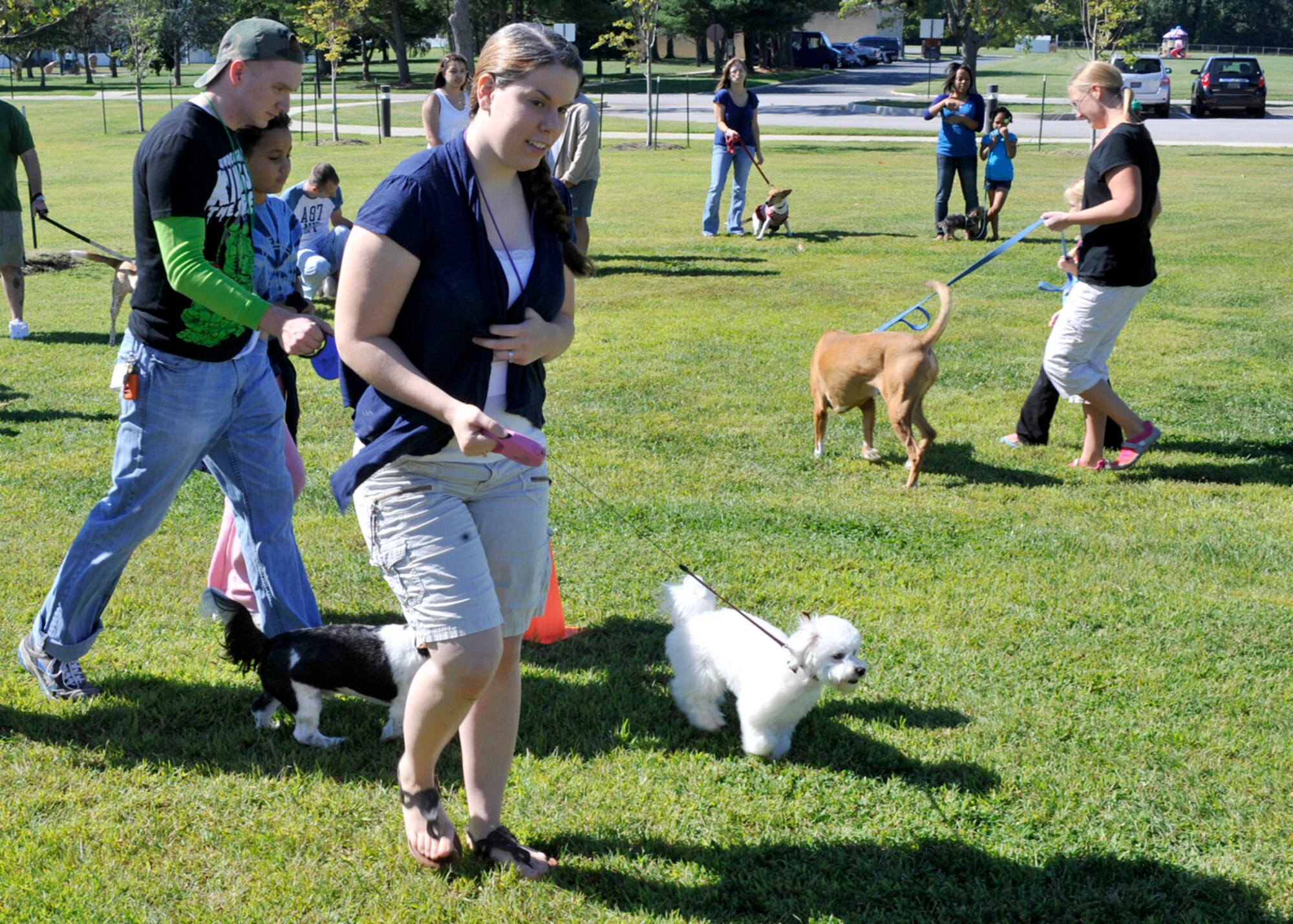 Miranda Watson walks her dog, Lilo, by the judges table as other pet owners prepare their animals Sep. 15, 2012, at the Pet Extravaganza at the Youth Center on Dover Air Force Base, Del. Watson and Lilo, along with her partner, Stitch, won first prize in the costume category. (U.S. Air Force photo by Tech. Sgt. Chuck Walker)