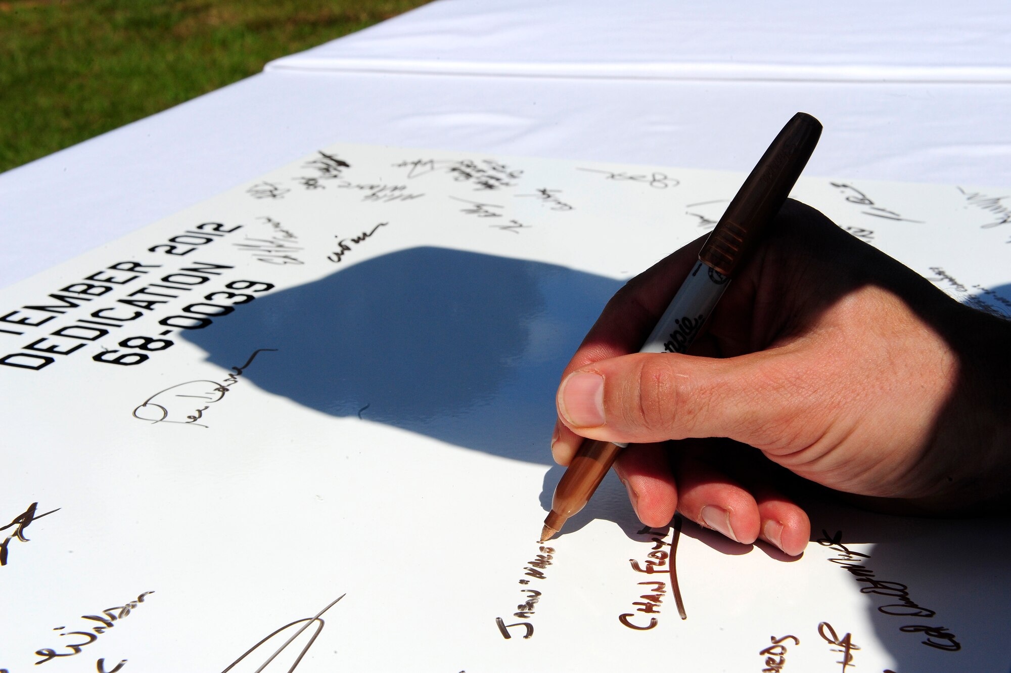 Those in attendance during the F-111 dedication were given an opportunity to sign a commemorative plaque that will be placed in the cockpit of the static display at Shaw Air Force Base, S.C., September 12, 2012. The plaque will stay in the cockpit of the static display while it remains at Shaw. (U.S. Air Force photo by Airman 1st Class Daniel Blackwell/Released)