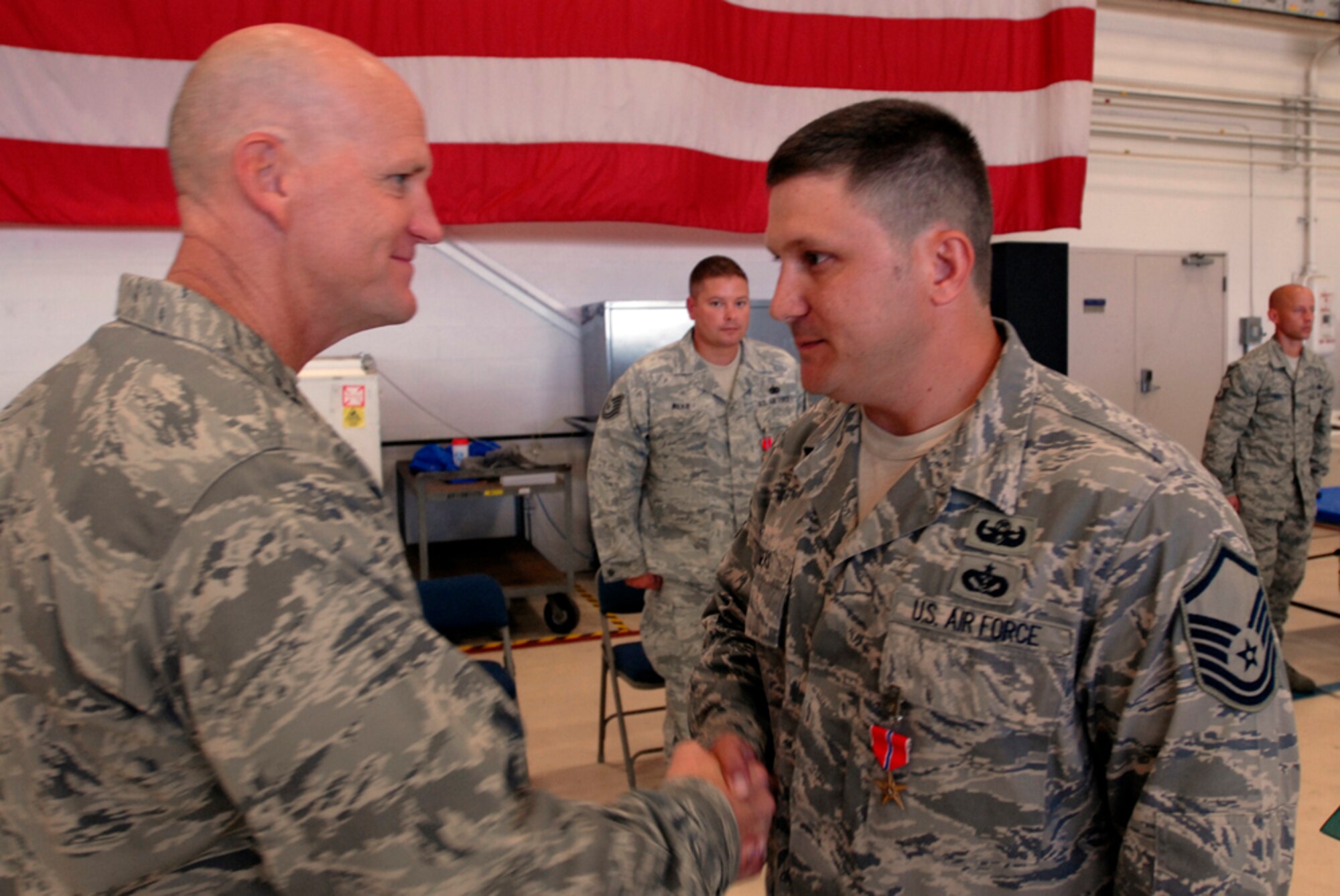 125th Fighter Wing Commander, Col. James Eifert, awards the Bronze Star to Master Sgt. Raleigh Rogers, 125th Explosive Ordinance Disposal (EOD) at a ceremony, August 19, 2012, 125th Fighter Wing, Florida Air National Guard, Jacksonville, Fla. Rogers distinguished himself while performing as an EOD team leader in Ghanzni Province, Afghanistan. Rogers found and cleared over 33 IED's on over 69 combat missions, destroyed over a thousand pounds of enemy weaponry, and cleared over 1200 miles of routes allowing freedom of movement for both special and conventional coalition forces.(Air National Guard photo by Staff Sgt. Jeremy Brownfield)