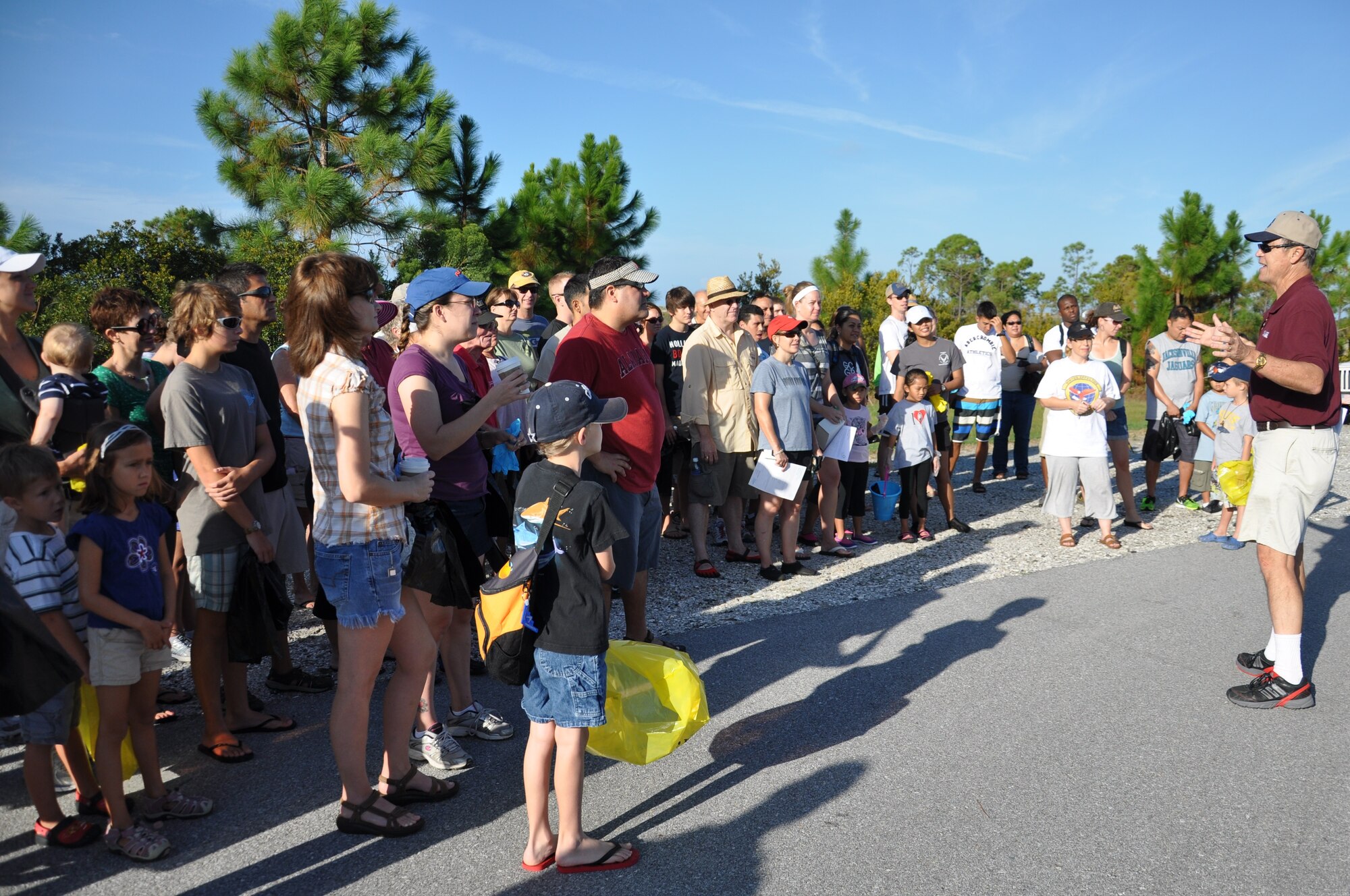Team Tyndall Annual International Coastal Cleanup volunteers gather for a short briefing before heading out to collect trash on the base’s coastline Sept. 15. (U.S. Air Force photo by Staff Sgt. Rachelle Elsea)