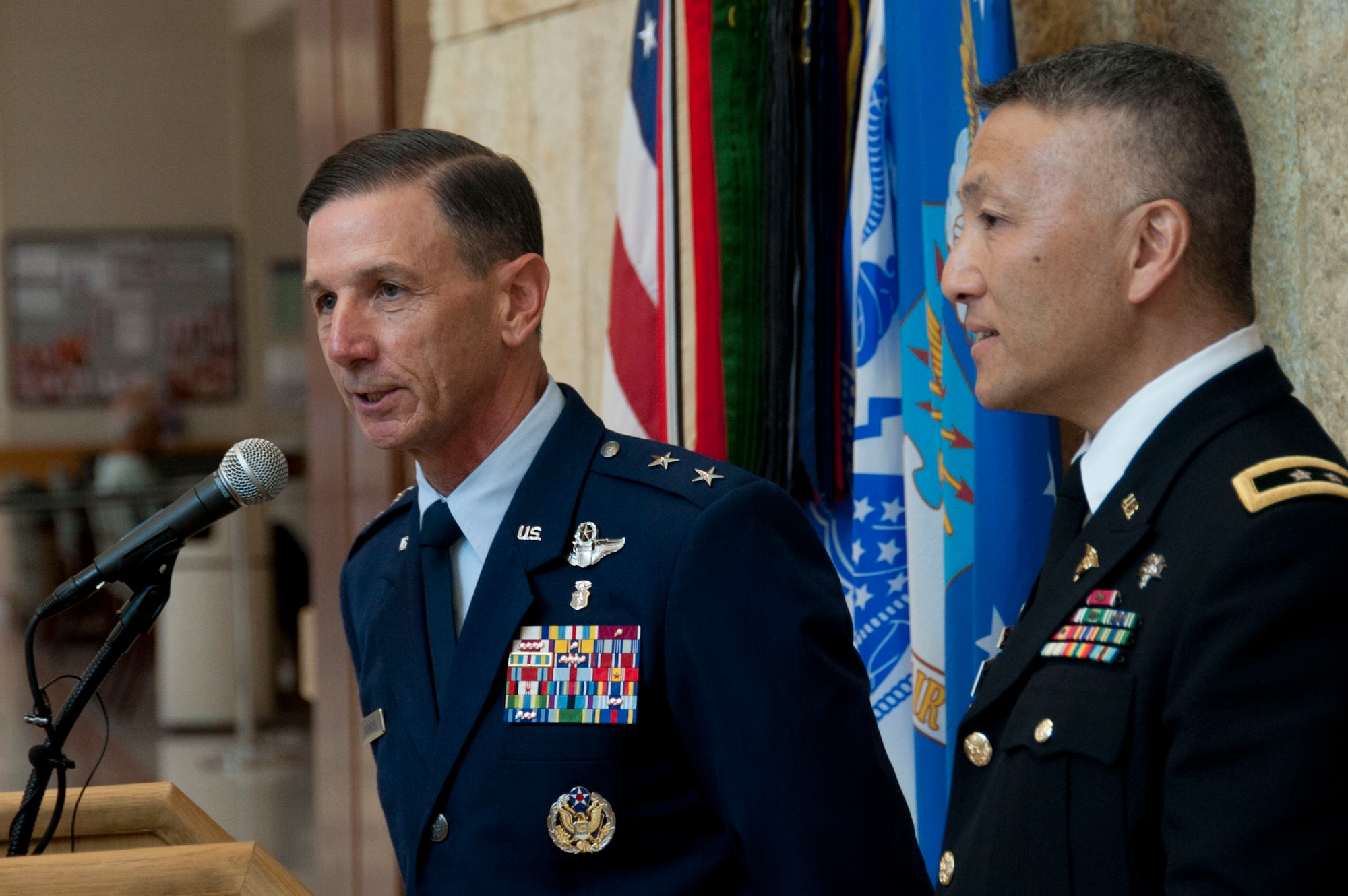 U.S. Air Force Maj. Gen. Byron Hepburn and Army Maj. Gen. Ted Wong speak during the San Antonio Military Health System one year anniversary celebration at the San Antonio Military Medical Center, Fort Sam Houston, Texas, Sept. 14.  Hepburn is the SAMHS director and the 59th Medical Wing commander. Wong is the deputy director and the Brooke Army Medical Center commander. (U.S. Air Force photo/SSgt. Corey Hook)
