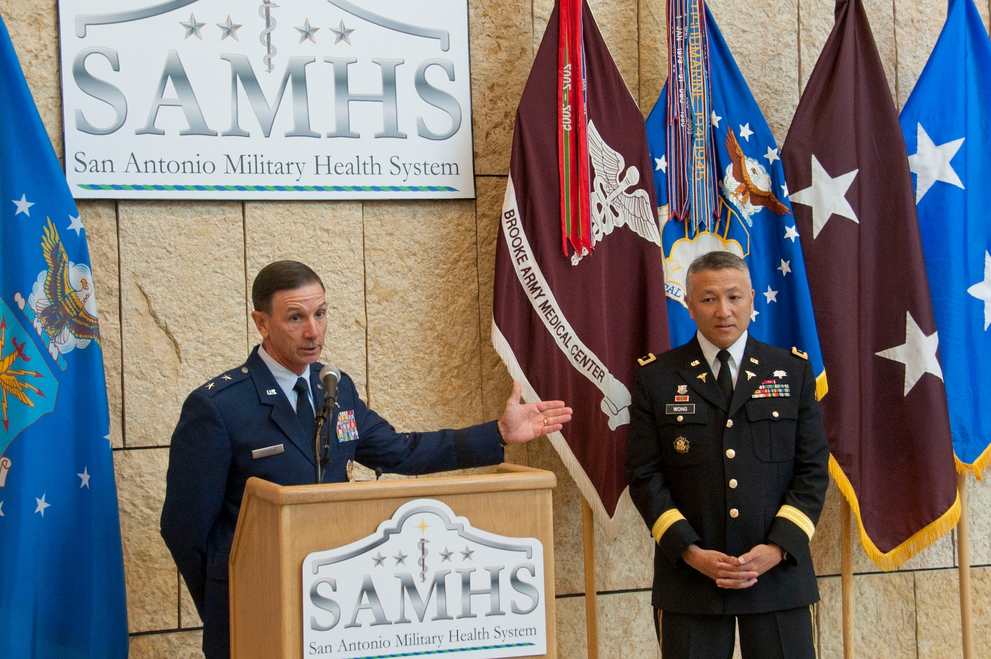 U.S. Air Force Maj. Gen. Byron Hepburn and Army Maj. Gen. Ted Wong speak during the San Antonio Military Health System one year anniversary  celebration at the San Antonio Military Medical Center, Fort Sam Houston, Texas, Sept. 14.  Hepburn is the SAMHS director and the 59th Medical Wing commander.  Wong is the deputy director and the Brooke Army Medical Center commander. (U.S. Air Force photo/SSgt. Corey Hook)
