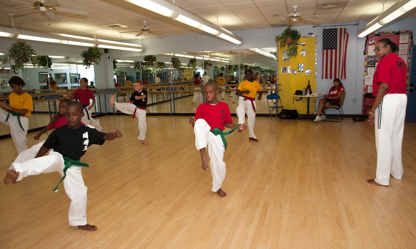 Master Lynnette Love observes her students as they perform a kata form during a scheduled class at the Love Academy at Andrews Youth Center on Aug. 14, 2012..  Love is an Olympic taekwando champion, and her story has inspired a movie called "Seoul, U.S.A.," which is being produced later this year.  (Photo/Bobby Jones)