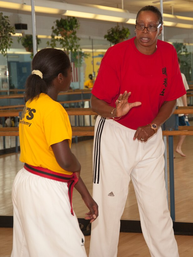 Master Lynnette Love, gives a student one-on-one instruction during a scheduled class at the Love Academy at Andrews Youth Center on Aug. 14, 2012.. Love is an Olympic taekwando champion, and her story has inspired a movie called "Seoul, U.S.A.," which is being produced later this year. (Photo/Bobby Jones)