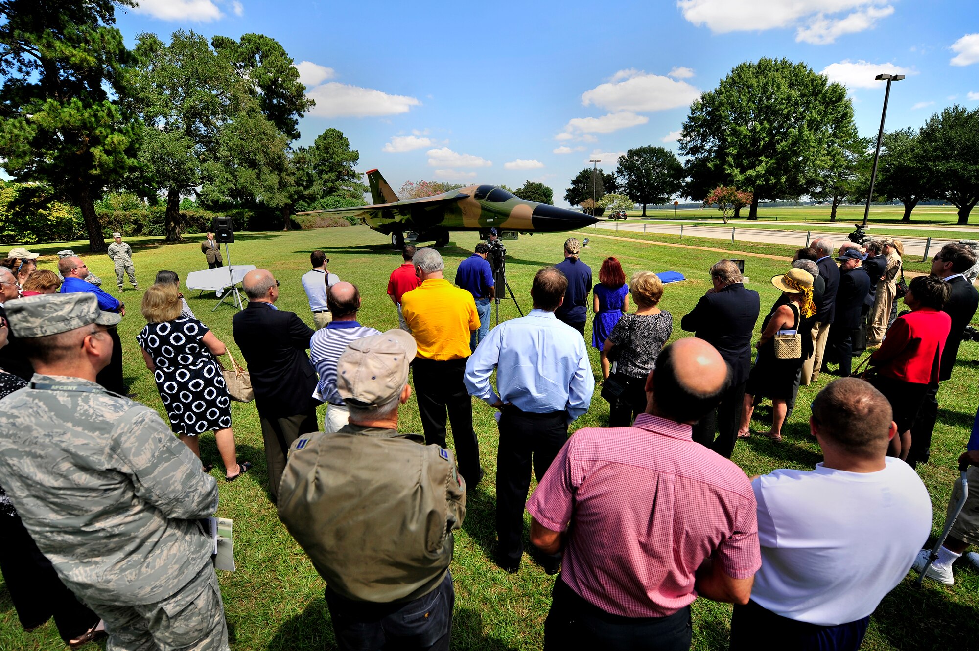 U.S. Air Force Col. Lance Kildron, 20th Fighter Wing vice commander (center) welcomes Airmen and guests to the F-111E Aardvark dedication ceremony, Sept. 12, 2012, Shaw Air Force Base, S.C. The F-111E is a significant part of the 20th Fighter Wing’s history as it was first flown as a part of the wings arsenal in 1970. Aircraft 68-0035 and 680045 landed at Royal Air Force Upper Heyford 42 years ago, starting a new era for the wing. (U.S. Air Force photo by Senior Airman Kenny Holston/Released) 