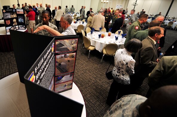 U.S. Air Force Airmen and guests in attendance at the F-111E Aardvark dedication ceremony view photo displays of the F-111E aircraft during the luncheon portion of the event, Sept. 12, 2012, Shaw Air Force Base, S.C. The F-111E is a significant part of the 20th Fighter Wing’s history as it was first flown as a part of the wings arsenal in 1970. Aircraft 68-0035 and 680045 landed at Royal Air Force Upper Heyford 42 years ago, starting a new era for the wing. (U.S. Air Force photo by Senior Airman Kenny Holston/Released) 