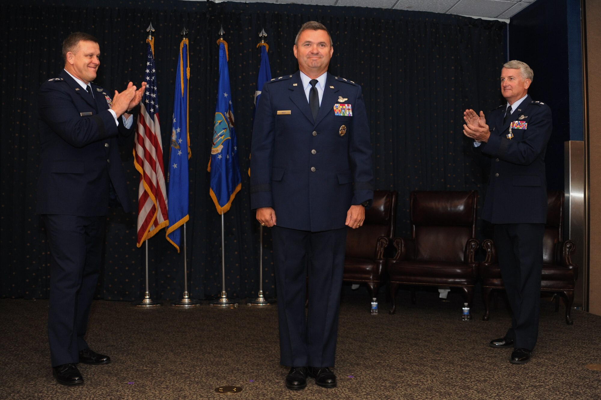 From the left: Assistant Vice Chief of Staff of the Air Force Lt. Gen. Frank Gorenc leads the applause for new Air Force Operational Test and Evaluation Commander Maj. Gen. Scott D. West joined by departing AFOTEC Commander Maj. Gen. David J. Eichhorn during a Sept. 13 change of command ceremony at Kirtland Air Force Base, N.M. (U.S. Air Force photo/Ken C. Moore)