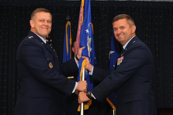 Maj. Gen. Scott D. West accepts command of the Air Force Operational Test and Evaluation Center from Assistant Vice Chief of Staff of the Air Force Lt. Gen. Frank Gorenc during a change of command ceremony at Kirtland Air Force Base, N.M. (U.S. Air Force photo/Ken C. Moore)