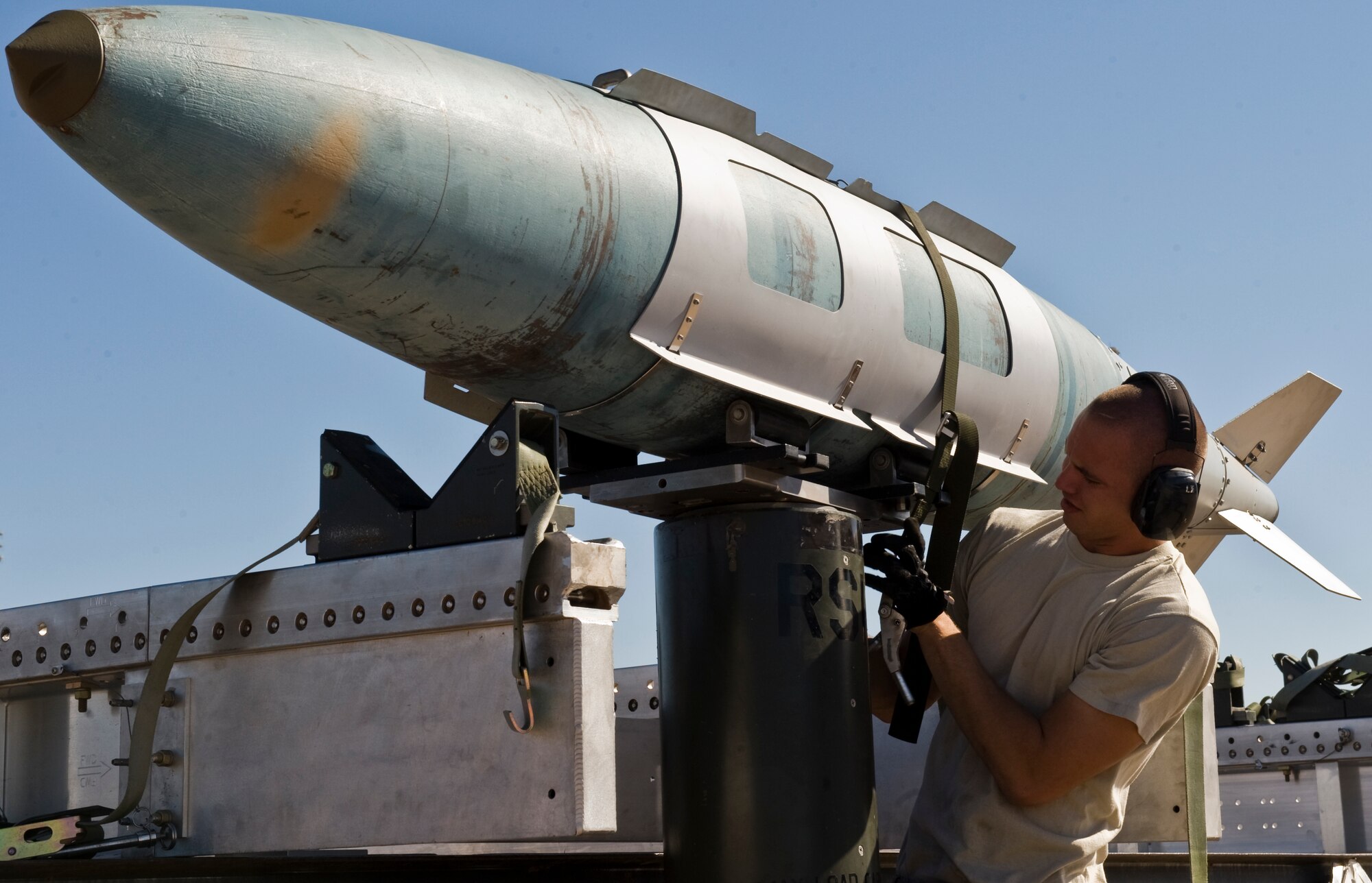 U.S. Air Force Airman 1st Class Dane Williamson, 7th Aircraft Maintenance Squadron, positions a joint direct attack munition onto a lift while training for the 3rd annual Global Strike Challenge Sept. 11, 2012, at Dyess Air Force Base, Texas. The competition consists of a uniform inspection, general knowledge test, tool inspection, munitions build, weapons load and a B-1 Bomber pre-flight inspection. (U.S. Air Force photo by Airman 1st Class Jonathan Stefanko/ Released)