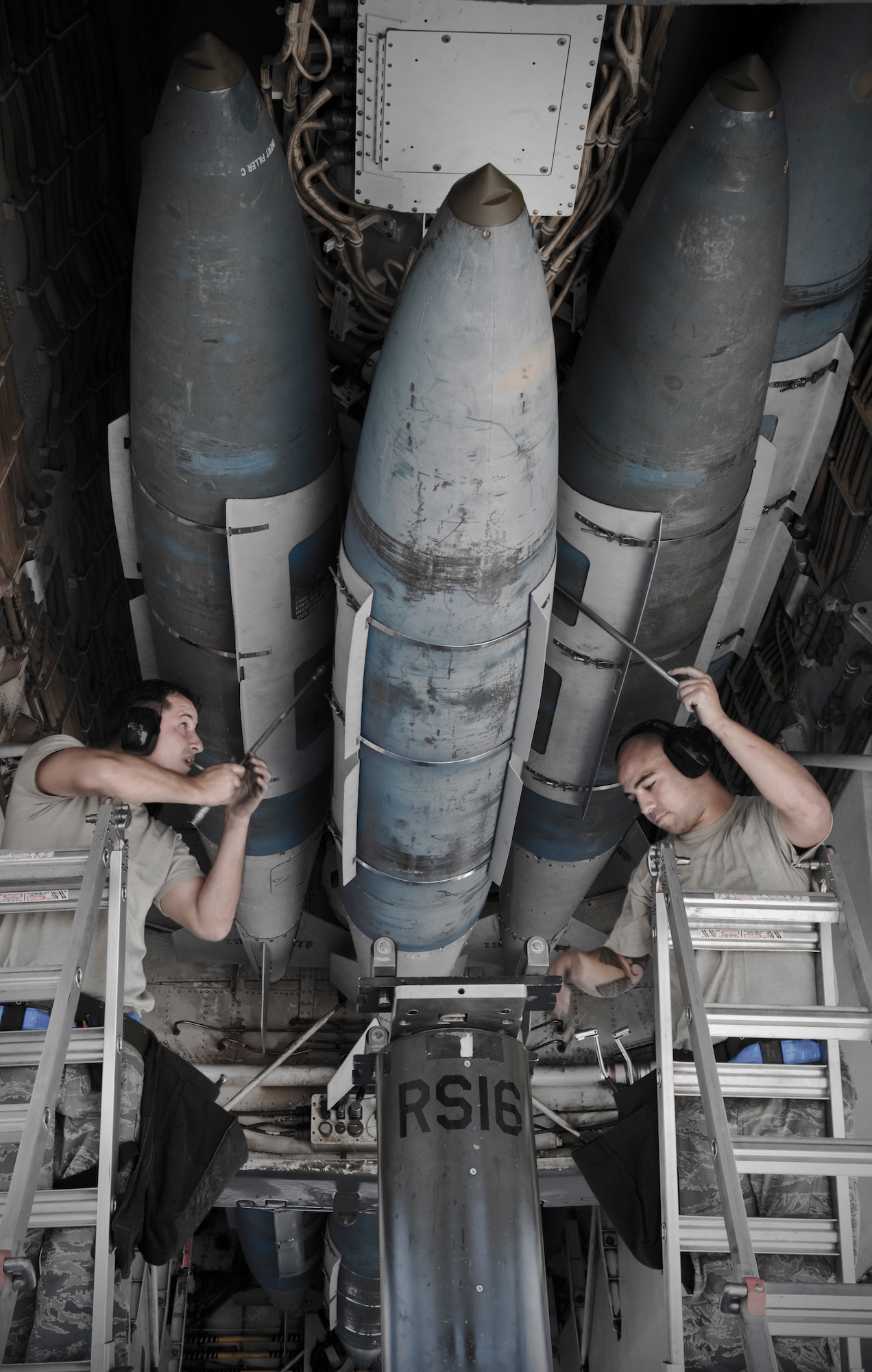 U.S. Air Force Tech. Sgt. James Travis and Staff Sgt. Justin Johnson from the 7th Maintenance Group attach a joint direct attack munition onto a B-1 bomber while training for the 3rd annual Global Strike Challenge Sept. 11, 2012, at Dyess Air Force Base, Texas. The competition consists of a uniform inspection, general knowledge test, tool inspection, munitions build, weapons load and a B-1 Bomber pre-flight inspection. (U.S. Air Force photo by Airman 1st Class Jonathan Stefanko/ Released)

