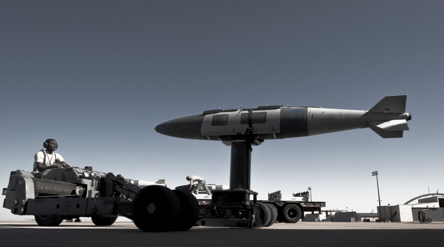 U.S. Air Force Senior Airman Maurice Brown, 7th Aircraft Maintenance Squadron, moves a joint direct attack munition while training for the 3rd annual Global Strike Challenge Sept. 11, 2012, at Dyess Air Force Base, Texas. The competition consists of a uniform inspection, general knowledge test, tool inspection, munitions build, weapons load and a B-1 Bomber pre-flight inspection. (U.S. Air Force photo by Airman 1st Class Jonathan Stefanko/ Released)