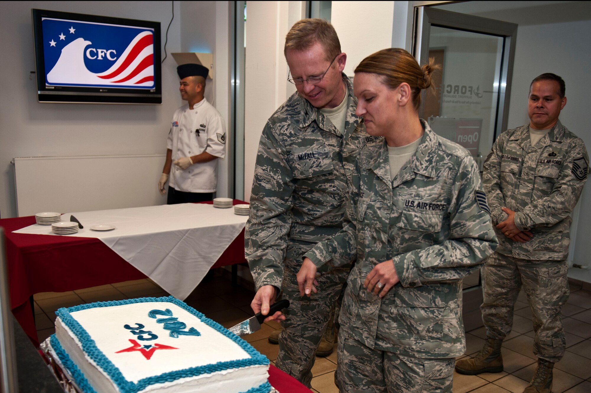 SPANGDAHLEM AIR BASE, Germany – Col. Joseph McFall, 52nd Fighter Wing vice commander, and Tech. Sgt. Shauna Arce, 606th Air Control Squadron, Combined Federal Campaign community area project officer, cut a cake during a CFC event inside the Mosel Hall Dining Facility here Sept. 17.  The Spangdahlem CFC campaign runs from Sept.17 – Nov. 16 and donations can be made through individual squadron unit coordinators or online at http://www.cfcoverseas.org.  Donations made to the CFC support eligible non-profit organizations which provide health and human services benefits throughout the world. (U.S. Air Force photo by Airman 1st Class Gustavo Castillo/Released)