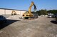 A construction worker uses an excavator to remove debris to clear a path for more equipment on Ramstein Air Base, Germany, Sept. 18, 2012. Demolition of the old Base Exchange is estimated to begin on October 5th. (U.S. Air Force photo/ Senior Airman Aaron-Forrest Wainwright)  