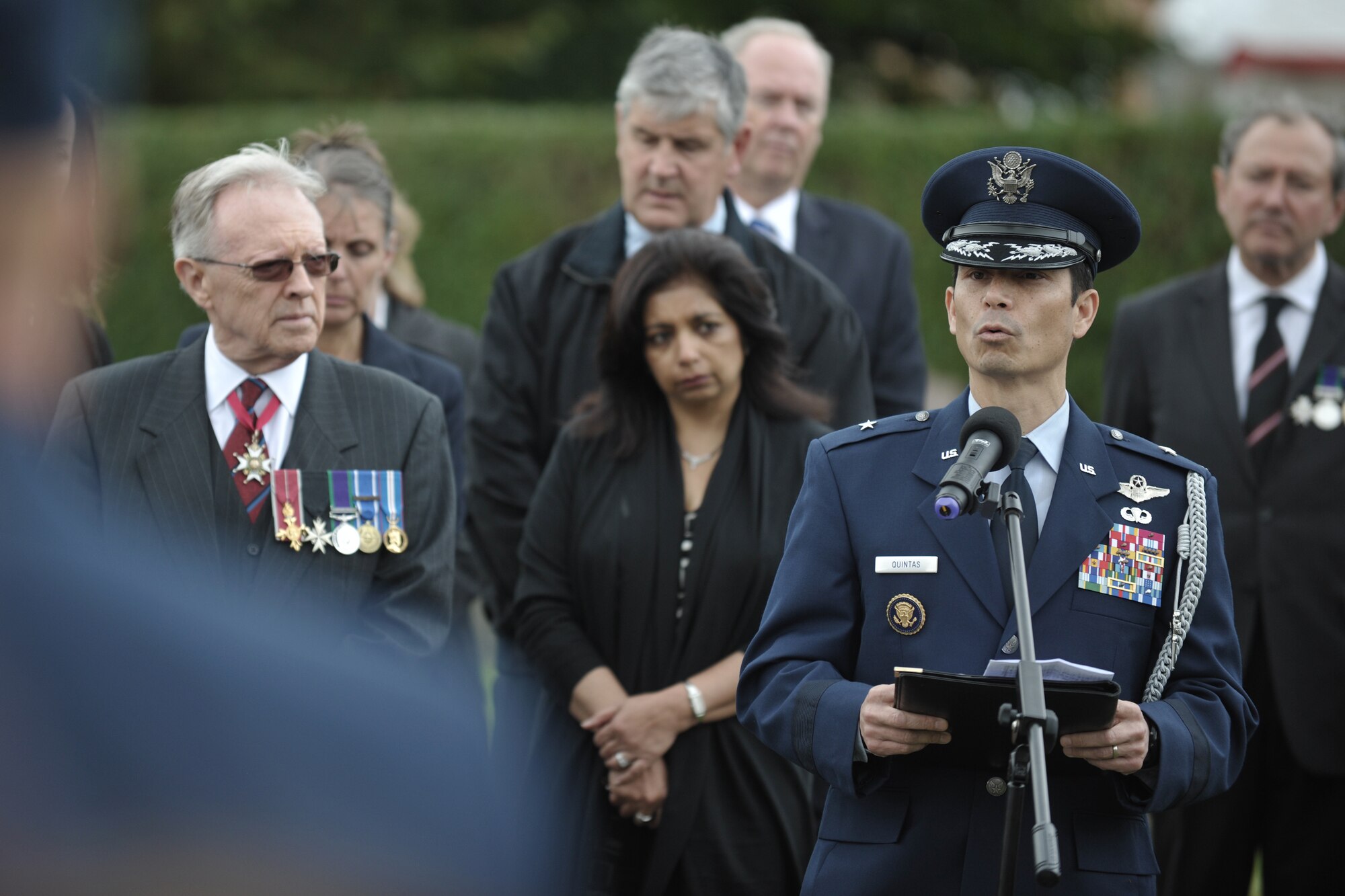 UPPER HEYFORD, United Kingdom – Brig. Gen. John Quintas, the Defense Attaché at the U.S. Embassy in London talks about Capt. Jerry Lindh, 55th Fighter Squadron F-111E pilot, and Maj. David “Mike” McGuire, 55th FS F-111E navigator, during an Act of Commemoration. The village of Upper Heyford, held the ceremony for Lindh and McGuire who died Sept. 17, 1992, when they decided to fly their crippled F-111E away from the villages of Upper Heyford and North Aston instead of ejecting. “Mike and Jerry were my friends and comrade-in-arms and their spirit lives on in the Airmen of today,” said Quintas.(U.S. Air Force photo by Master Sgt. John Barton)