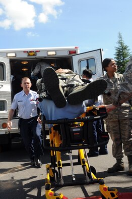 Members of the 35th Medical Group load simulated victims into an ambulance during an Emergency Management Exercise at Misawa Air Base, Japan, Sept. 17, 2012. Medics from the 35 MDG responded to the scene to provide medical care for victims of a simulated explosion. The EME was an exercise conducted as part of the base's Combined Unit Inspection. (U.S. Air Force photo/Airman 1st Class Kia Atkins) 
