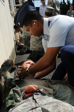U.S Air Force 1st Lt. Dipta Kazi, right, 35th Logistics Readiness Squadron material management flight commander, provides self-aid buddy care to a role player with a simulated abdominal injury after an explosion during an Emergency Management Exercise at Misawa Air Base, Japan, Sept. 17, 2012. The exercise tested the wing's response to a mass casualty event, accountability procedures and response to an increased terrorist threat as part of the 35th Fighter Wing's Combined Unit Inspection. (U.S. Air Force photo/Airman 1st Class Kia Atkins) 
