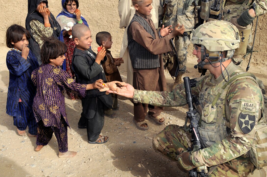 U.S. Army Lt. Col. Steven Soika gives an Afghan girl a toy animal during Operation Southern Strike III in the Spin Boldak district of Afghanistan's Kandahar province, Sept. 6, 2012. Soika is the commander of the 2nd Infantry Division's 5th Battalion, 20th Infantry Regiment, 3rd Stryker Brigade Combat Team.