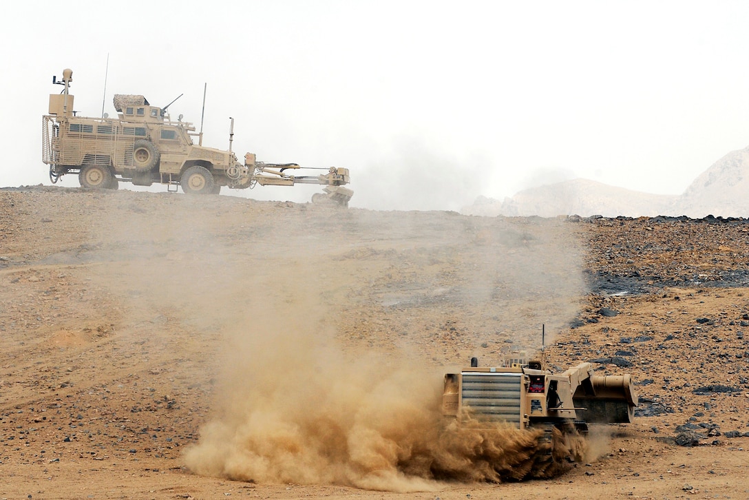 U.S. soldiers clear a hill of improvised explosive device threats along ...