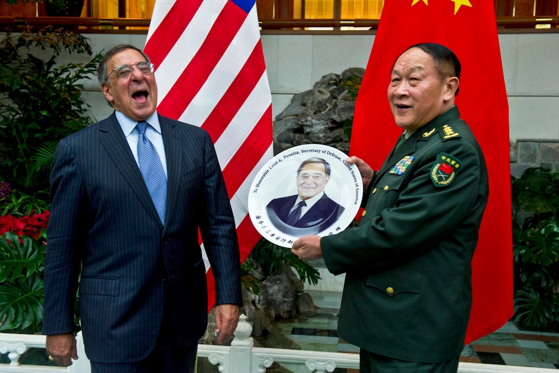 U.S. Defense Secretary Leon E. Panetta receives a plate as a gift to commemorate his visit to China from Chinese Defense Minister Gen. Liang Guanglie after an official dinner in Beijing, Sept. 18, 2012.