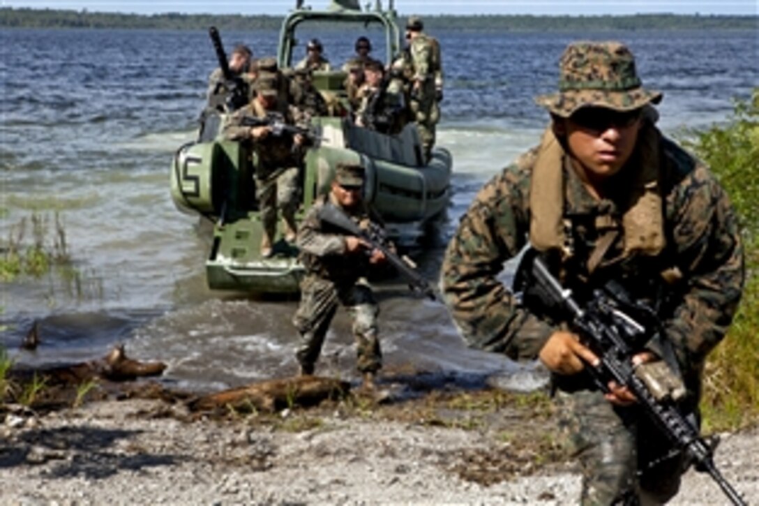 U.S. Marines and sailors insert into a landing zone as part of a scenario while conducting riverine training during UNITAS-Partnership of the Americas 2012 on Camp Blanding, Fla., Sept. 8, 2012. The event gives the participating troops from Brazil, Canada, Chile, Colombia, Ecuador, Mexico, Paraguay, Peru, the United States and Uruguay an opportunity to exercise critical thinking based on realistic scenarios, reinforce essential tactics and techniques.