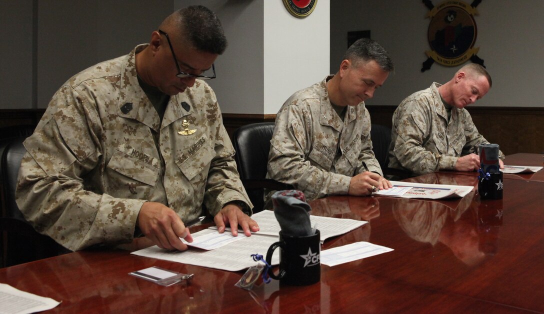 Sgt. Maj. Ernest K. Hoopii, sergeant major of Marine Corps Installations East – Marine Corps Base Camp Lejeune (left), Col. Timothy S. Mundy, assistant chief of staff for operations of 2nd Marine Division (middle), Col. Edward D. Banta, commanding officer 2nd Marine Logistics Group (right), look through the expansive collection of charitable organizations in search of their favorite charities they wish to donate to through the Combined Federal Campaign. The Combined Federal Campaign has a total of 2,683 charities hoping for donations from service members and federal employees.