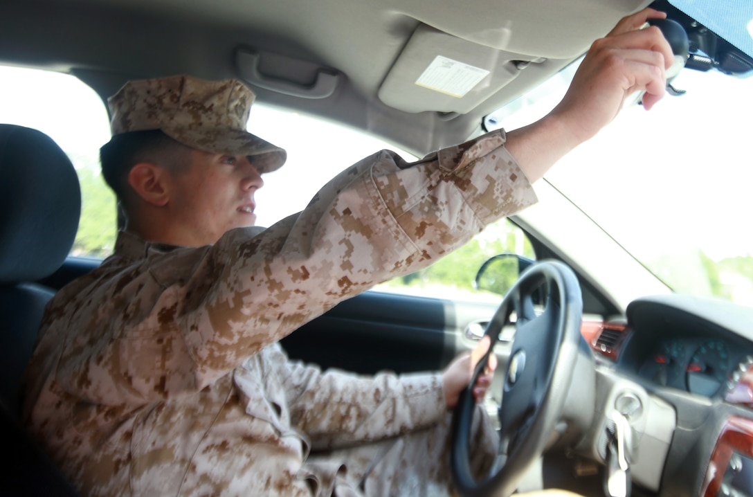 Lance Cpl. Carlos B. Chacon, the driver for the 2nd Marine Logistics Group commanding officer, checks his rearview mirror aboard Camp Lejeune, N.C., Sept. 17, 2012. Chacon, a native of Trinidad, Colo., was hand-selected by Staff Sgt. Victor D. Velez, the 2nd MLG commanding officer’s enlisted assistant, and Sgt. Maj. William T. Stables, the 2nd MLG’s previous sergeant major, to be the commanding general’s driver.