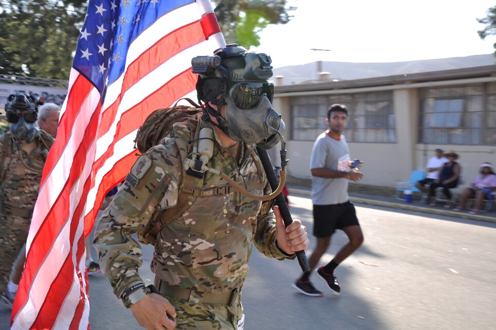 A Marine Special Operations Command (MARSOC) Marine runs bearing the American Flag, during the Heartbreak Ridge Half Marathon at Camp Pendleton's 43 Area Parade Deck, Sept. 8.