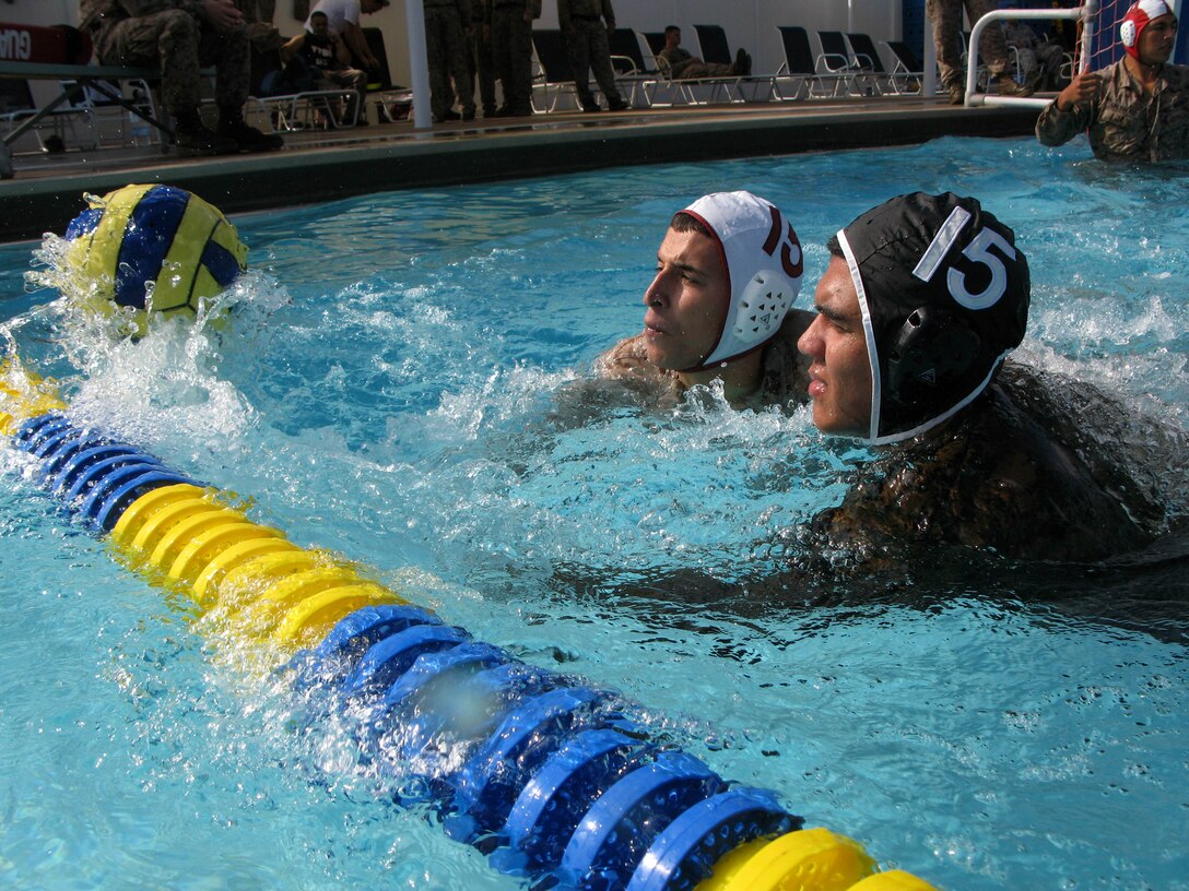 Opposing players dash to a water polo ball in an attempt to gain possession during a combat water polo tournament at Camp Pendleton’s 13 Area Pool, Sept. 12. Marine Corps Community Services’ Pendleton Cup Series provided Marines and sailors with an opportunity to build unit cohesion and camaraderie while competing for monetary prizes that will be awarded to their respective units.
