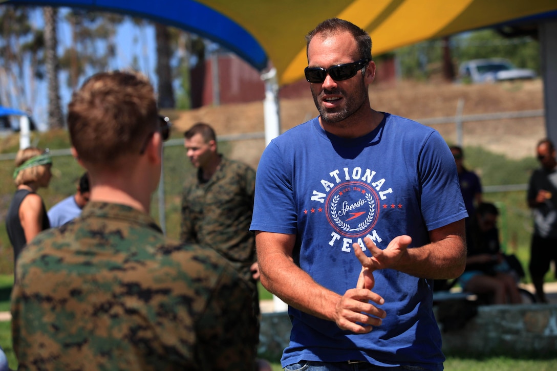 Ryan Bailey, a former USA Men’s Water Polo Team Olympian interacts with a Marine during his surprise visit during a combat water polo tournament at Camp Pendleton’s 13 Area Pool, Sept. 12. Marine Corps Community Services’ Pendleton Cup Series provided Marines and sailors with an opportunity to build unit cohesion and camaraderie while competing for monetary prizes that will be awarded to their respective units.