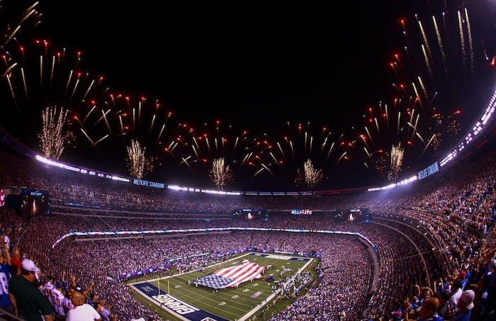 EAST RUTHERFORD, N.J. – Marines, sailors, Coast Guardsmen, airmen and soldiers unfurled an American flag across the field during a pre-game ceremony before the New York Giants versus Dallas Cowboys game at MetLife Stadium, Sept. 5.  More than 60 service members presented the large flag as Queen Latifah sang the national anthem.(U.S. Marine Corps photo by Cpl. Caleb T. Gomez).