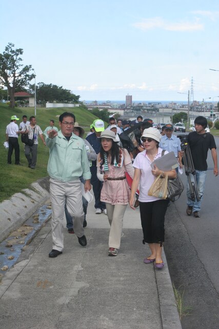 Ginowan City Mayor Atsushi Sakima (left) directs Japanese residents of Ginowan City and Chatan Town through an evacuation route as part of Constant Vigilance 2012 at Camp Foster Sept. 12. CV-12 included an evacuation drill designed to ensure the safety of Marine Corps personnel, families and Japanese residents in the event of a crisis by rehearsing the establishment of shelters and safe havens and movement of individuals out of danger areas.