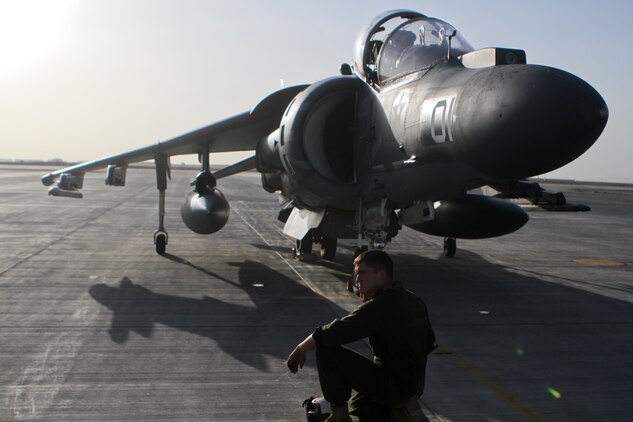 A Marine waits for the engines of an AV-8B Harrier II Plus aircraft to cool down before working on it, Sept. 18. Marine Attack Squadron 211, 3rd Marine Aircraft Wing (Forward), provides air support throughout Helmand and Nimroz provinces.