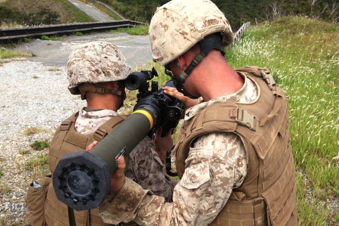 Lance Cpl. Colby T. Jones loads a high explosive, dual purpose rocket into a shoulder-launched multipurpose assault weapon at Camp Schwab Sept. 19. Marines participated in a two-day weapons training event, which included firing the M249 squad automatic weapon, M240B medium machine gun, MK19 40 mm grenade launcher, .50?caliber Browning heavy machine gun and the SMAW. Jones is a combat engineer squad automatic weapon with 9th Engineer Support Battalion, 3rd Marine Logistics Group, III Marine Expeditionary Force.