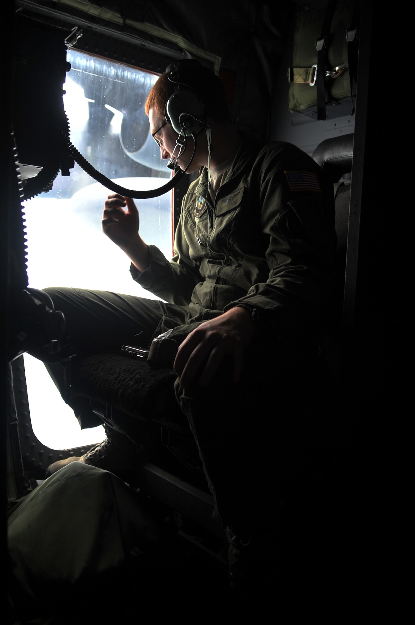 Aerial gunner Airman 1st Class Sean checks out the Korean landscape as an AC-130U Spooky gunship flies toward Pilsung Range during exercise Teak Knife 12-3 over the Republic of Korea, Sept. 12, 2012. During Teak Knife 12-3 U.S. forces partnered with Republic of Korea counterparts to conduct live-fire close air support training. (U.S. Air Force photo/Staff Sgt. Craig Cisek)