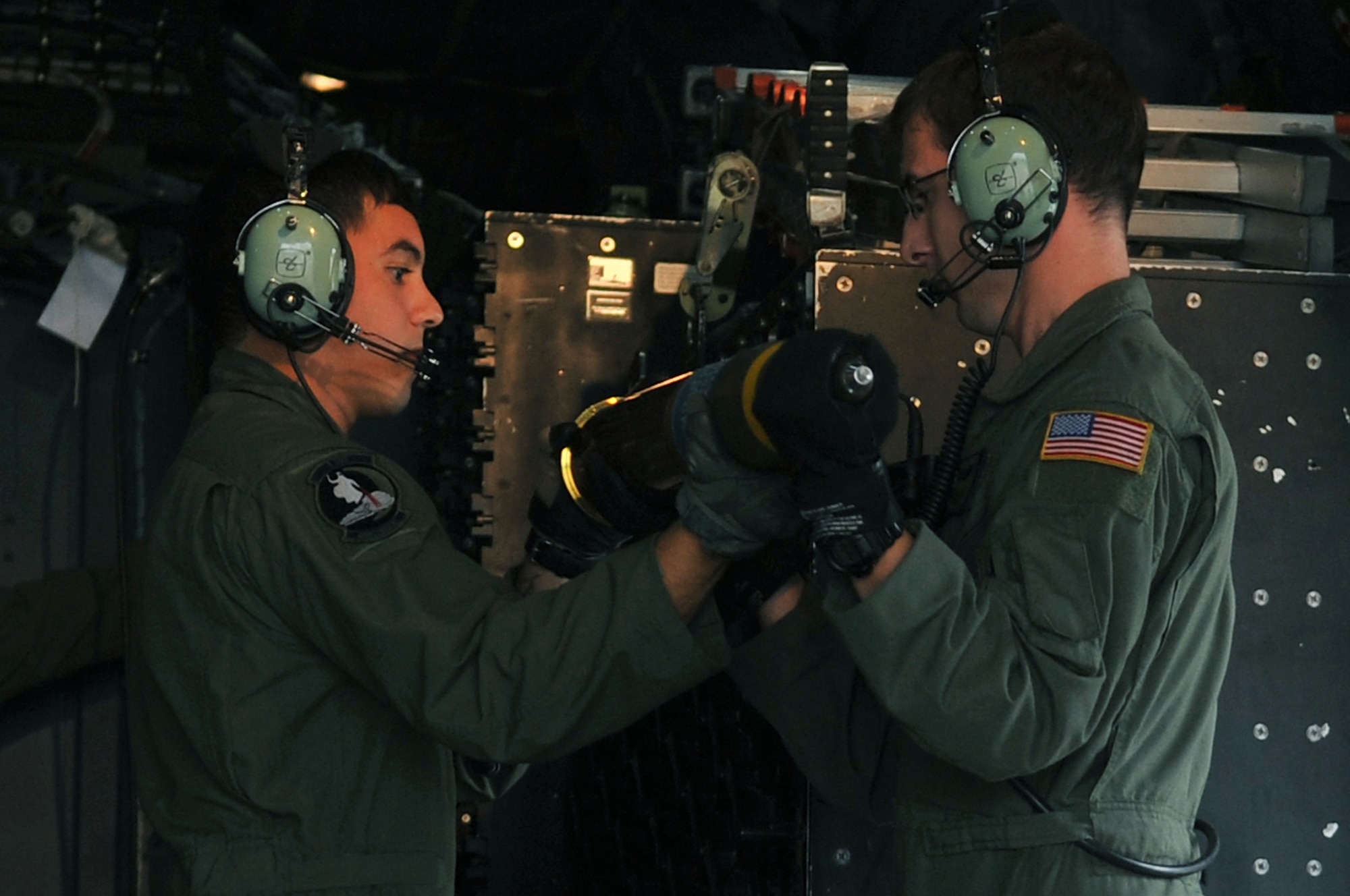 Aerial gunners Senior Airman Manuel and Airman 1st Class John load a 105mm round into an M102 cannon aboard an AC-130U Spooky gunship during exercise Teak Knife 12-3 at Osan Air Base, Republic of Korea, Sept. 12, 2012.  The exercise is designed to enhance the combat readiness of U.S. and Republic of Korea Special Operations and supporting forces through combined and joint live-fire training. The AC-130U incorporates side-firing weapons integrated with sophisticated sensor, navigation and fire control systems to provide surgical firepower or area saturation, at night and in adverse weather. Sensors allow the gunship to visually or electronically identify friendly ground forces and targets any place, any time. (U.S. Air Force photo/Staff Sgt. Craig Cisek)