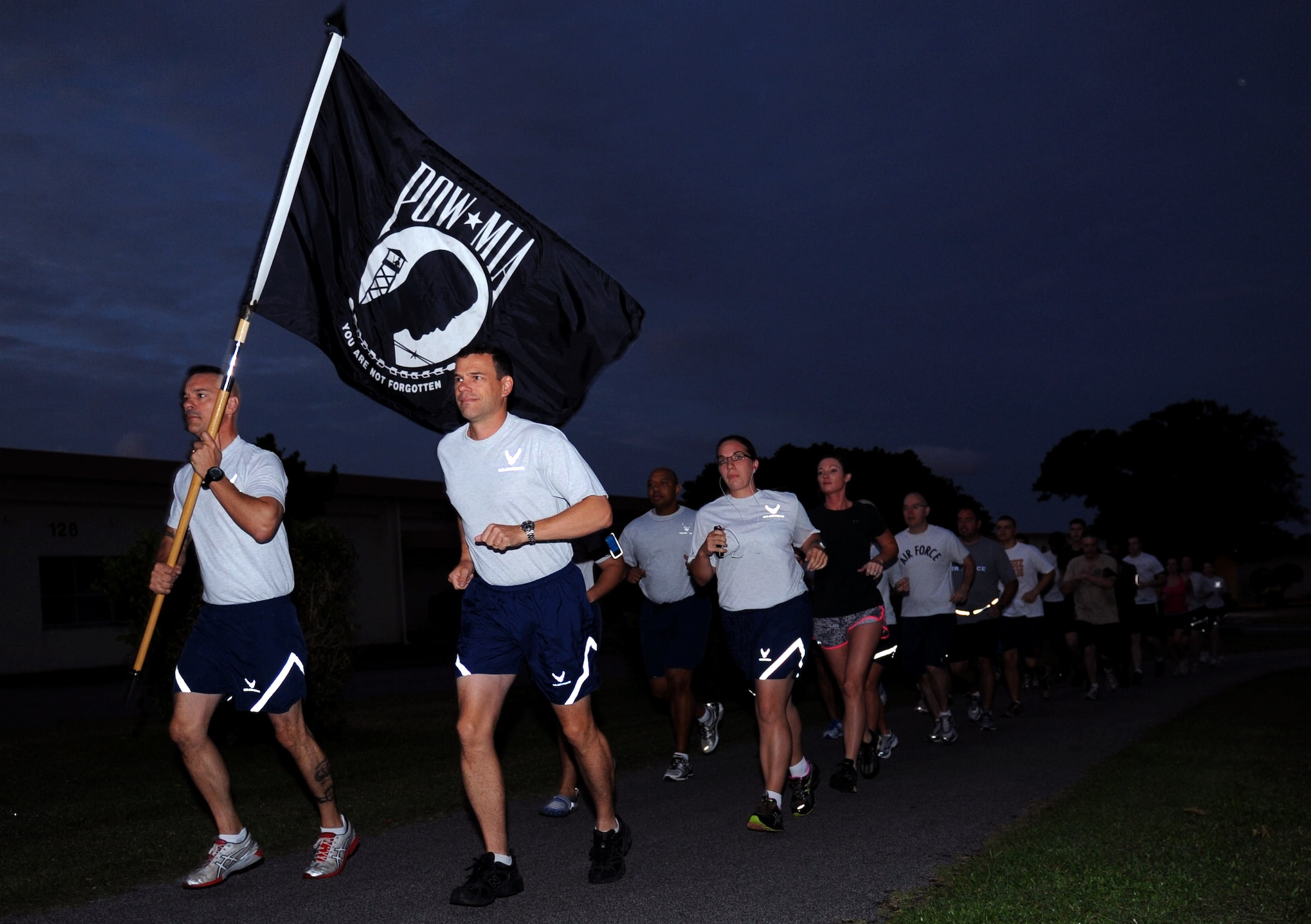 U.S. Air Force Brig. Gen. Matt Molloy, 18th Wing commander, and Chief Master Sgt. Mark Marson, 18th Wing command chief, lead members of Kadena's Wing Staff Agencies in a 24-hour Prisoners of War/Missing in Action Vigil run at Marek Park on Kadena Air Base, Japan, Sept. 20, 2012. The run will end at 6 a.m. Sept. 21 followed by a flag ceremony at the 18th Wing Headquarters, Bldg. 10 at 6:30 a.m. The vigil run is in honor of National POW/MIA Recognition Day, held on the 21st. (U.S. Air Force photo/Airman 1st Class Hailey R. Davis)
