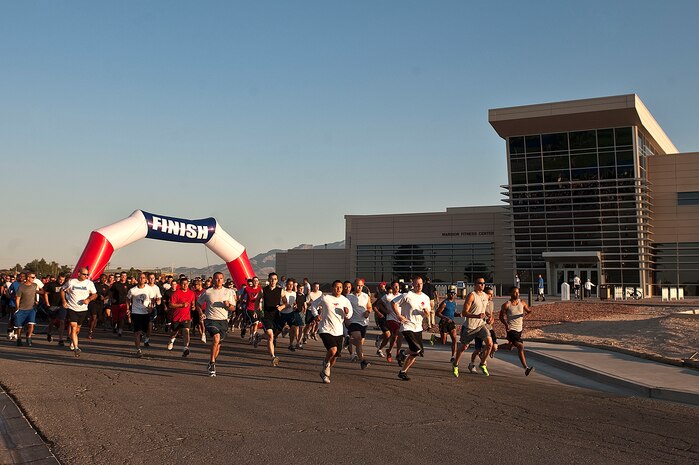 Service members and family members start the United States Air Force five-kilometer birthday run at the Warrior Fitness Center Sept. 18, 2012, at Nellis Air Force Base, Nev. The run was a way to celebrate the USAF's 65th birthday and honor those who serve and who have served in our Nation?s youngest branch of service. (U.S. Air Force photo by Staff Sgt. Christopher Hubenthal)