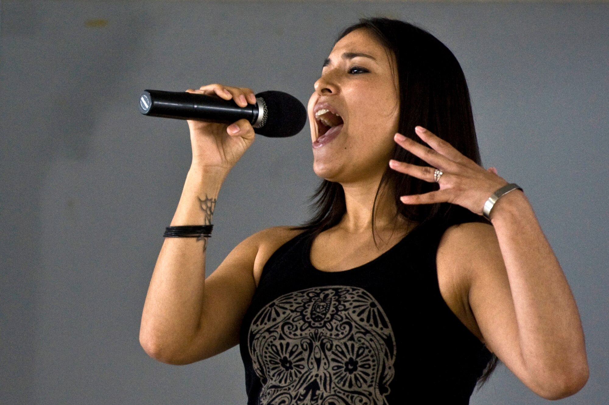 Staff Sgt. Adlea Avalos, 99th Security Forces Squadron armory noncommissioned officer in charge, sings during Retiree Appreciation Day Sept. 15, 2012, at Nellis Air Force Base, Nev. More than 810 retirees and their families came out for information, food and entertainment. (U.S. Air Force photo by Airman 1st Class Matthew Lancaster)
