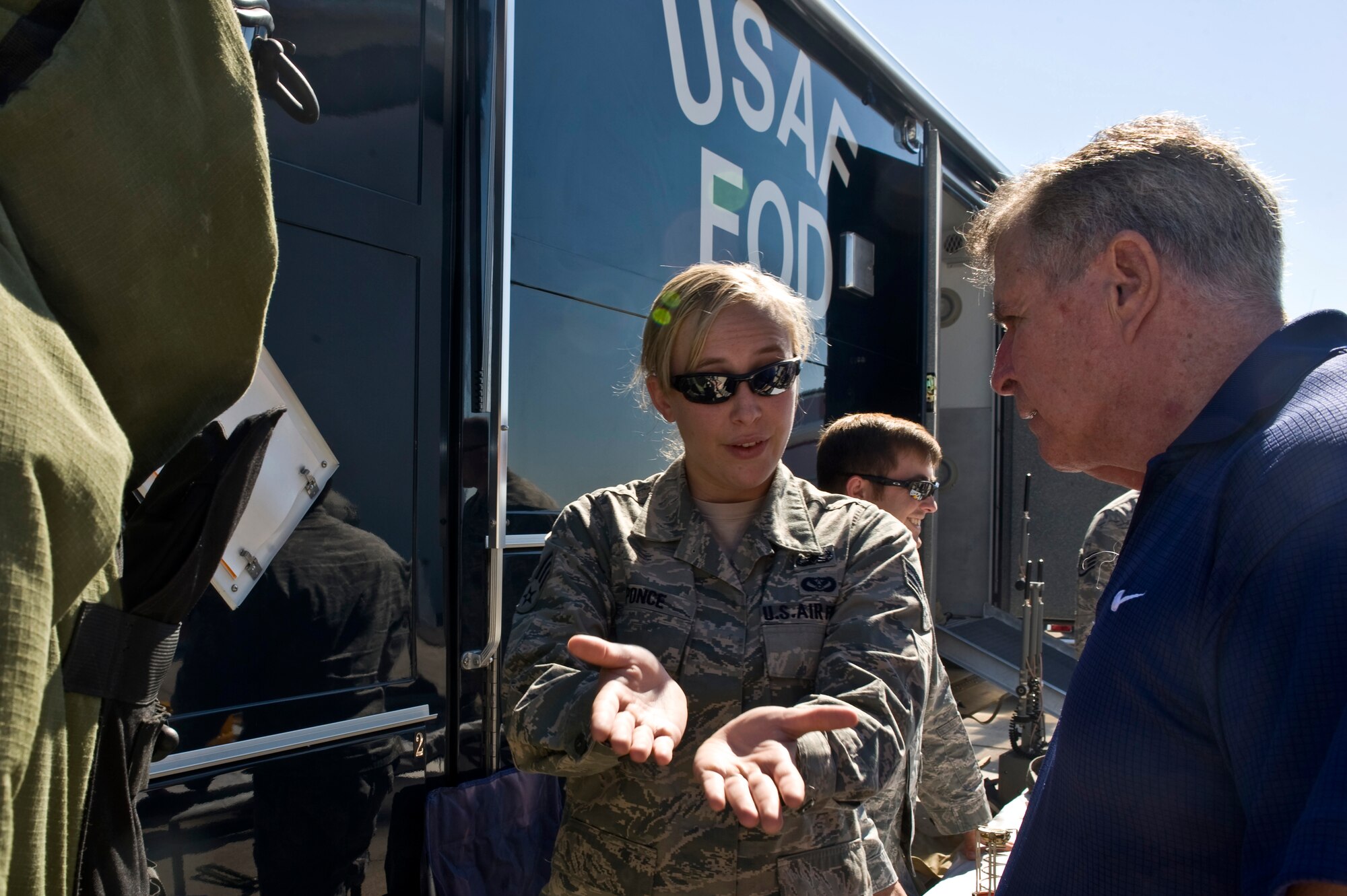 Airman 1st Class Amanda Ponce, 99th Civil Engineer Squadron explosive ordnance disposal technician, talks to Theodore Swenson, a United States Air Force retiree, about  EOD's mission during Retiree Appreciation Day, Sept. 15, 2012, at Nellis Air Force Base, Nev. Retiree Appreciation Day provides current information and resources while showing appreciation to those that served. (U.S. Air Force photo by Airman 1st Class Matthew Lancaster)
