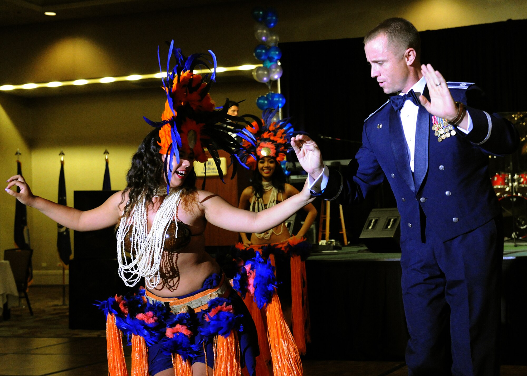 A Hawaiian performer dances center stage with an audience member at the Joint Base Pearl Harbor-Hickam 65th Air Force Ball at the Hilton Hawaiian Village Sept. 14, 2012. The ball celebrated the Air Force's 65th year as a separate service and paid tribute to the heroes that have served throughout history. (U.S. Air Force photo/Tech. Sgt. Jerome S. Tayborn)