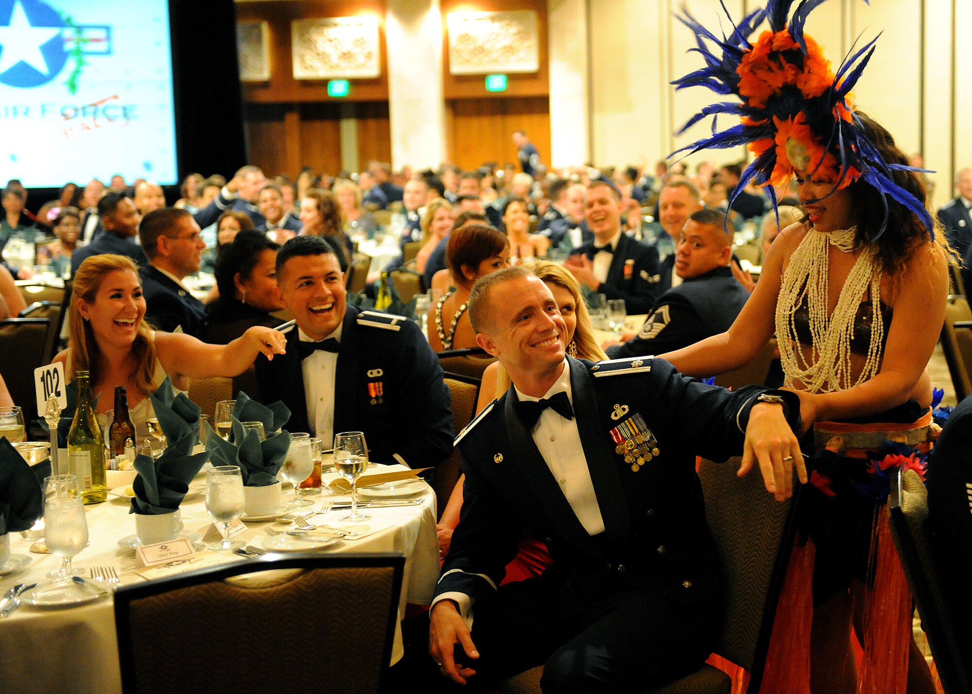 A Hawaiian performer invites an audience member from the Joint Base Pearl Harbor-Hickam 65th Air Force Ball to dance center stage at the Hilton Hawaiian Village Sept. 14, 2012. The ball celebrated the Air Force's 65th year as a separate service and paid tribute to the heroes that have served throughout history. (U.S. Air Force photo/Tech. Sgt. Jerome S. Tayborn)