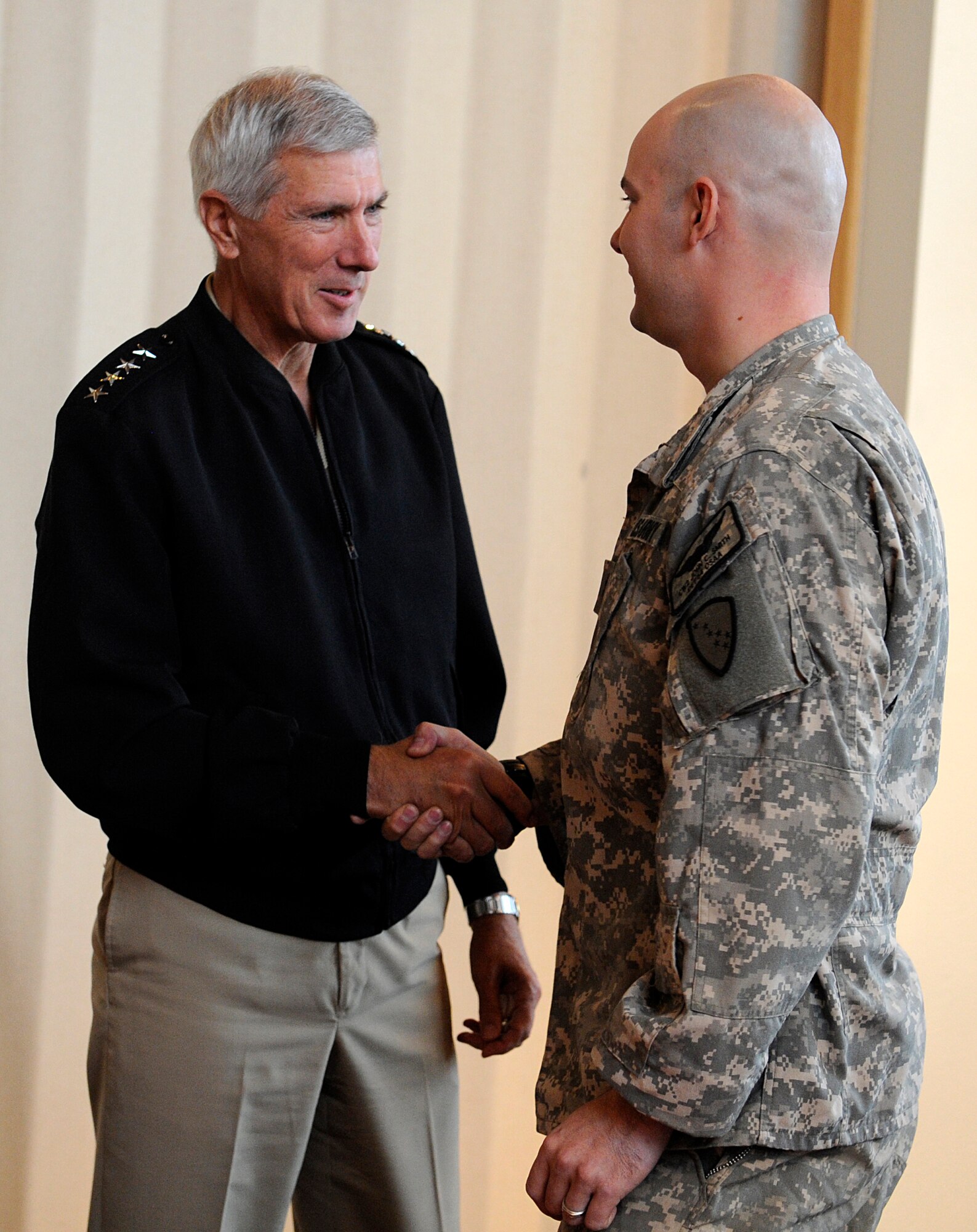 Adm. Samuel J. Locklear III, United States Pacific Command commander, introduces himself to Chief Warrant Officer 2 John Smith, Alaska National Guard C-12 Huron passenger aircraft pilot, at the Wilderness Inn Dining Facility on Joint Base Elmendorf-Richardson, Sept. 18, 2012. This is Locklear's first visit to JBER as the PACOM commander. (U.S. Air Force photo/Staff Sgt. Zachary Wolf) 