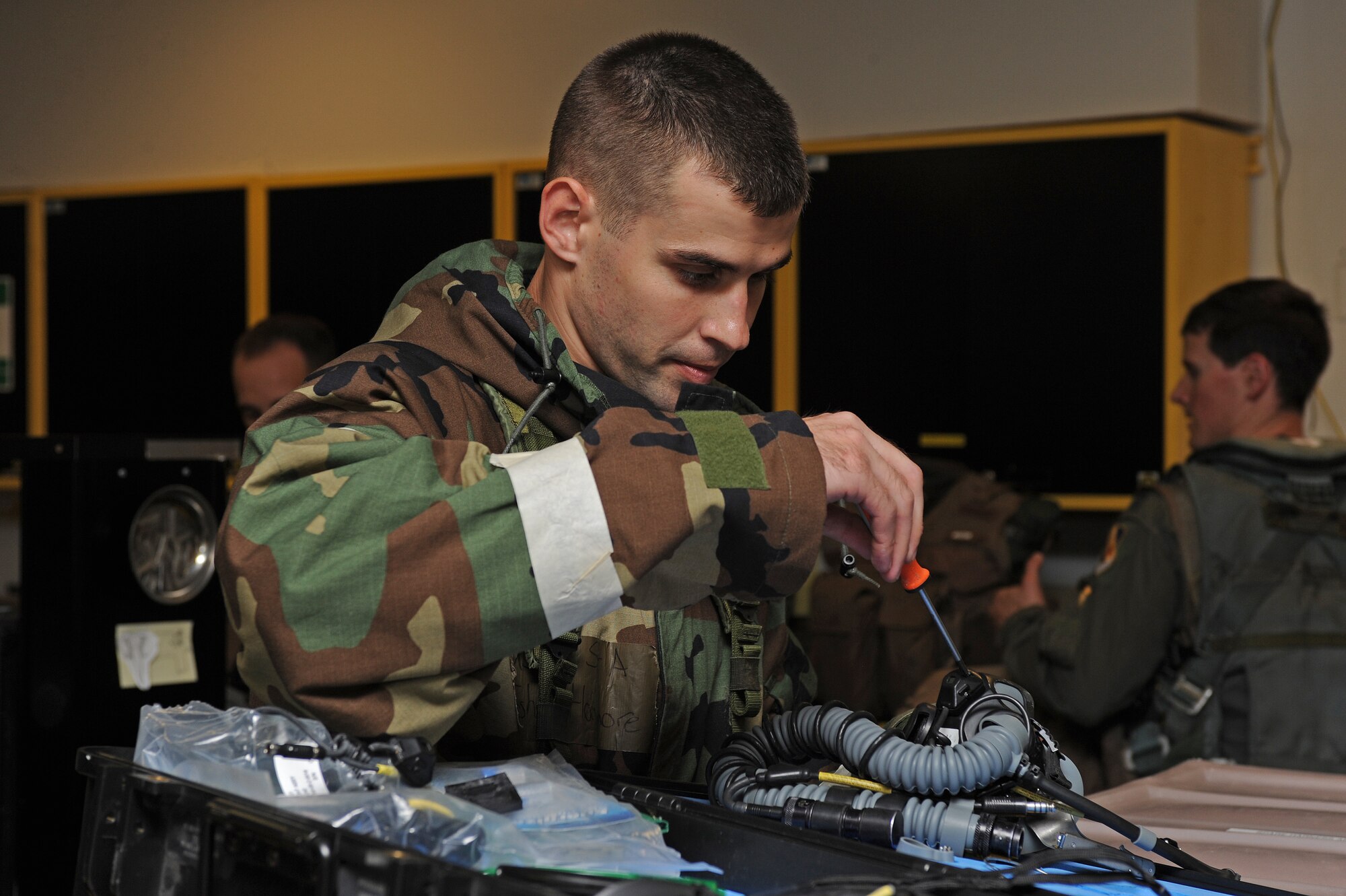 U.S. Air Force Senior Airman John Haymore, 4th Operational Support Squadron aircrew flight equipment journeyman, replaces a mask on a helmet during Phase II of Operational Readiness Exercise Coronet Warrior 12-04 at a simulated deployed location on Seymour Johnson Air Force Base, N.C., Sept. 19, 2012. AFE personnel are responsible for ensuring aircrew’s equipment functions properly. (U.S. Air Force photo/Airman 1st Class John Nieves Camacho/Released)