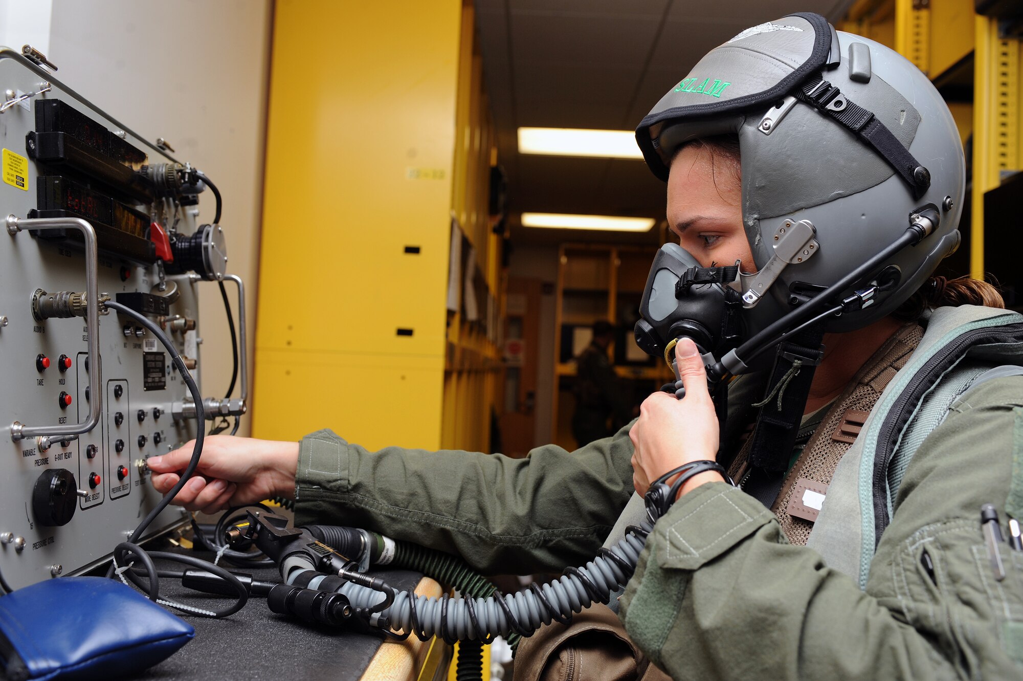 U.S. Air Force Capt. Patricia Nadeau, 335th Fighter Squadron weapon systems officer, starts the combined aircrew systems tester during Phase II of Operational Readiness Exercise Coronet Warrior 12-04 at a simulated deployed location on Seymour Johnson Air Force Base, N.C., Sept. 19, 2012. The tester ensures aircrew equipment is functioning up to standards. (U.S. Air Force photo/Airman 1st Class John Nieves Camacho/Released)