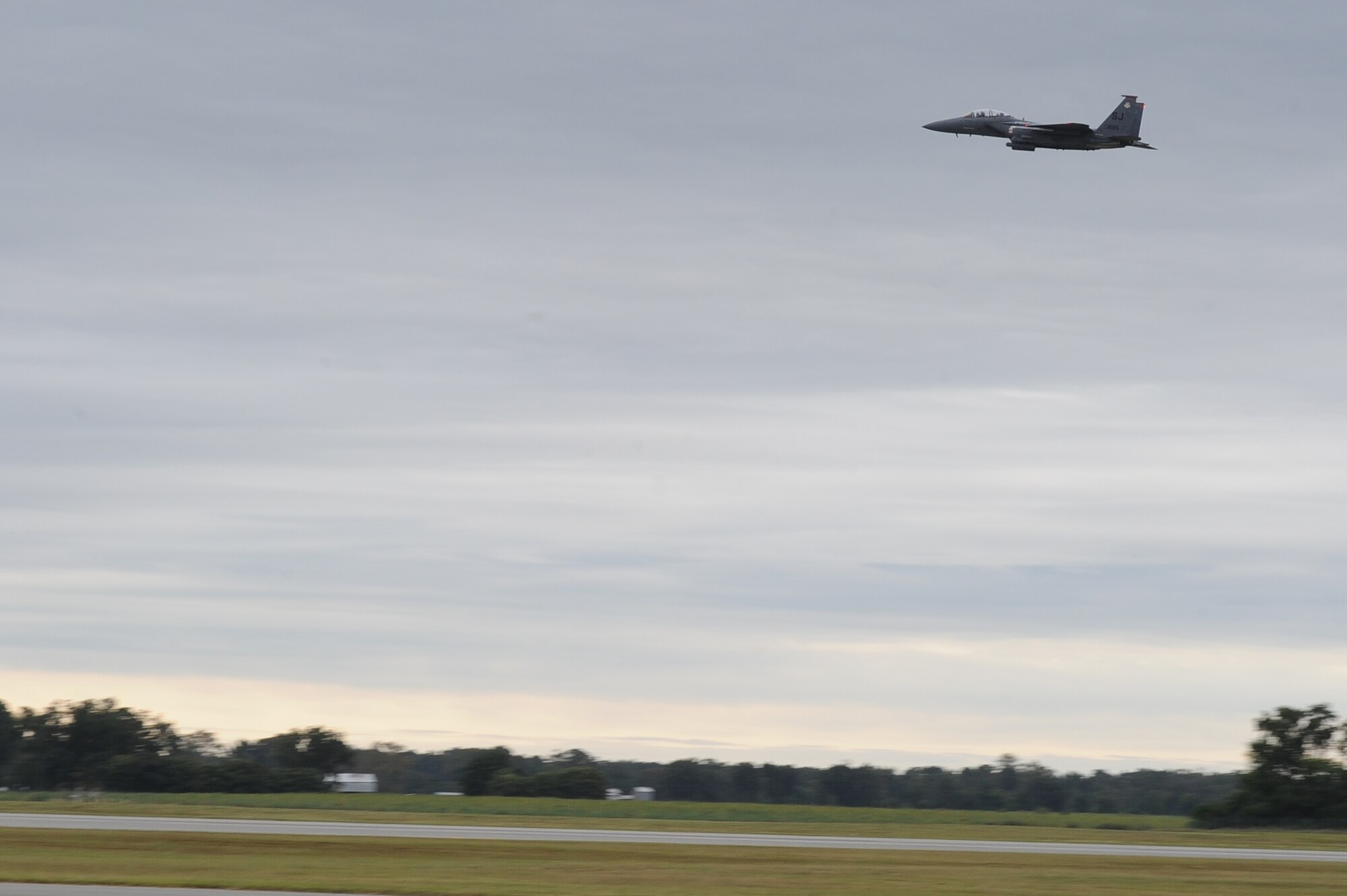 An F-15E Strike Eagle flies over the runway during Phase II of Operational Readiness Exercise Coronet Warrior 12-04 at a simulated deployed location on Seymour Johnson Air Force Base, N.C., Sept. 19, 2012. During the exercise, the F-15Es simulated a deployment with the mission of eliminating all enemy threats on the ground and in the air as well as protecting the base. (U.S. Air Force photo/Airman 1st Class John Nieves Camacho/Released)