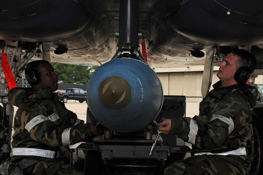 U.S. Air Force Staff Sgts. Steven Brown, 4th Maintenance Operation Squadron weapons crew chief, and Thomas Williams, 4th MOS weapons crew member, guide a GBU-31 missile into position on an F-15E Strike Eagle during Phase II of Operational Readiness Exercise Coronet Warrior 12-04 at a simulated deployed location on Seymour Johnson Air Force Base, N.C., Sept. 19, 2012. During CW 12-04, Airmen highlight their ability to position, employ and sustain forces in a deployed environment. (U.S. Air Force photo/Airman 1st Class John Nieves Camacho/Released)