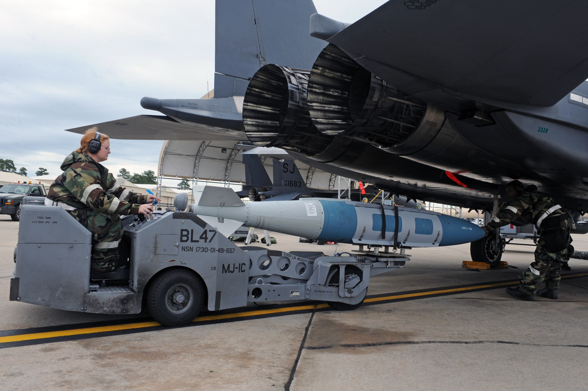 U.S. Air Force Airmen work together to place a GBU-31 missile onto an F-15E Strike during Phase II of Operational Readiness Exercise Coronet Warrior 12-04 at a simulated deployed location on Seymour Johnson Air Force Base, N.C., Sept. 19, 2012. Maintenance personnel prepare jets to deploy and accomplish mission requirements during each ORE. (U.S. Air Force photo/Airman 1st Class John Nieves Camacho/Released)