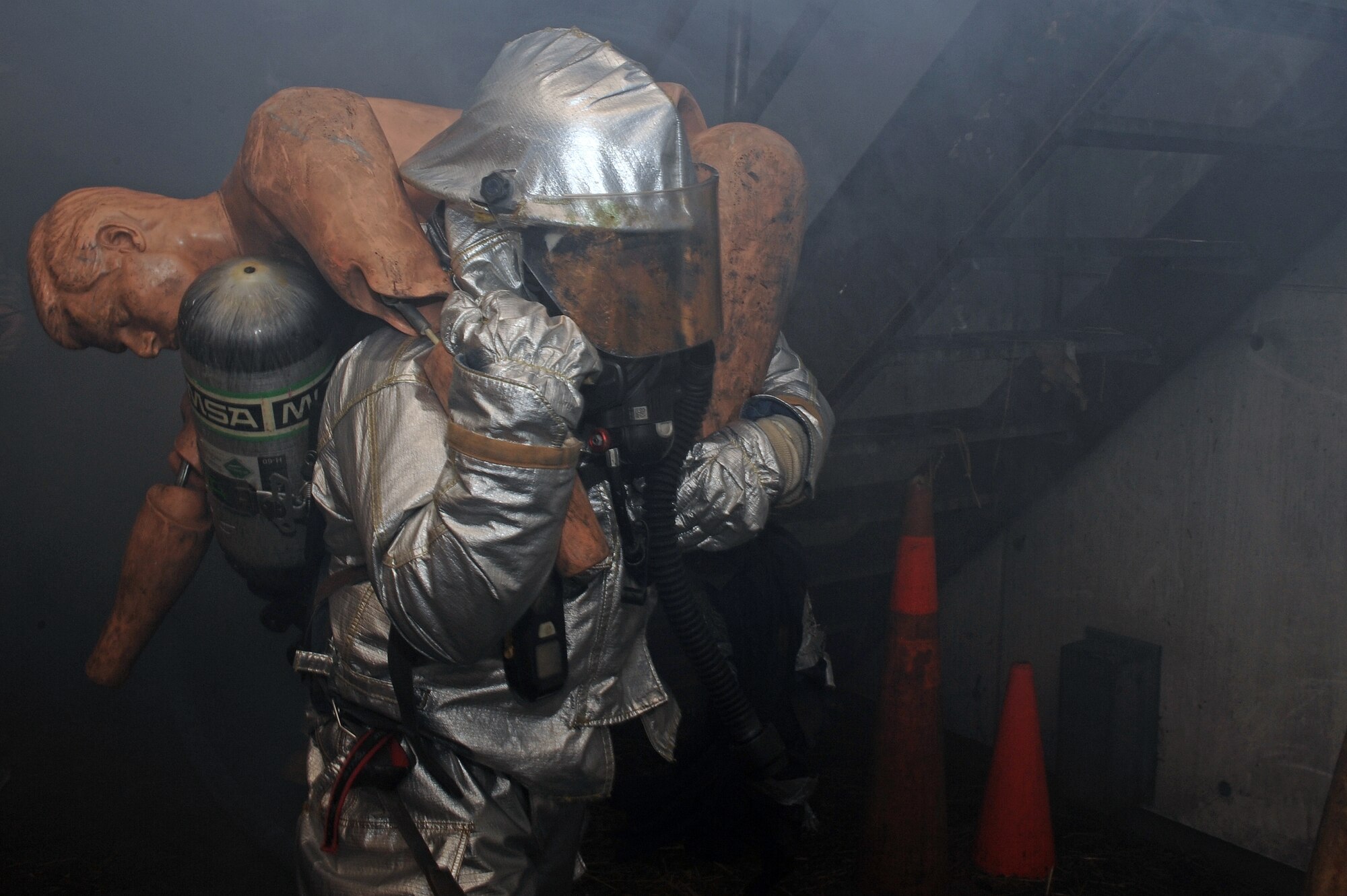 U.S. Air Force Airman 1st Class Raymond Vollintine, 4th Civil Engineer Squadron firefighter, performs a fireman's carry on a training dummy during Phase II of Operational Readiness Exercise Coronet Warrior 12-04 at a simulated deployed location on Seymour Johnson Air Force Base, N.C., Sept. 19, 2012. The fireman's carry is used to get injured personnel quickly evacuated from danger. (U.S. Air Force photo/Airman 1st Class John Nieves Camacho/Released)