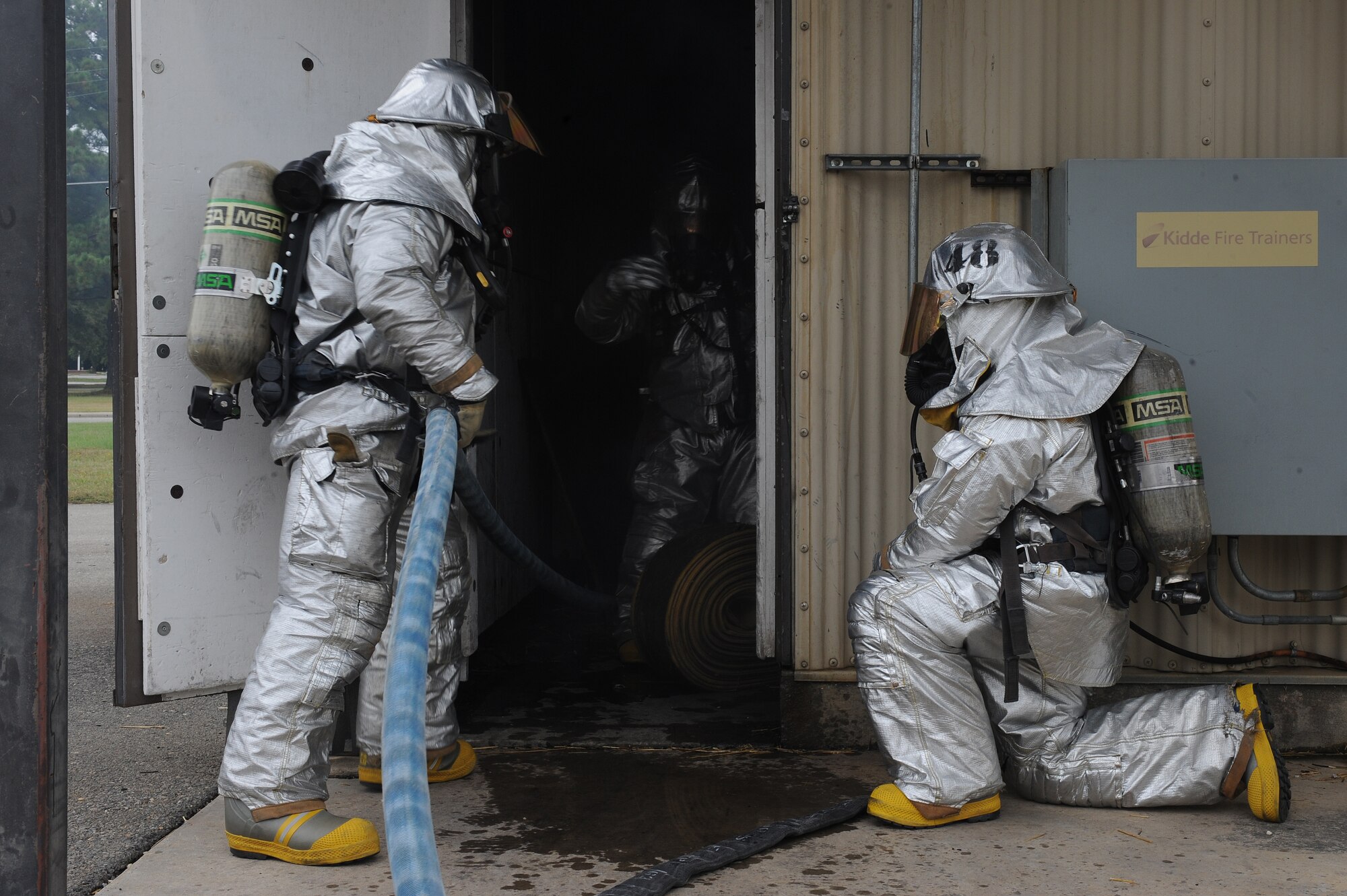 U.S. Air Force Airmen from the 4th Civil Engineer Squadron fire emergency services flight respond to a staged burning building call during Phase II of Operational Readiness Exercise Coronet Warrior 12-04 at a simulated deployed location on Seymour Johnson Air Force Base, N.C., Sept. 19, 2012. The 4th Fighter Wing is conducting multiple OREs to prepare for an Operational Readiness Inspection in 2013. (U.S. Air Force photo/Airman 1st Class John Nieves Camacho/Released)