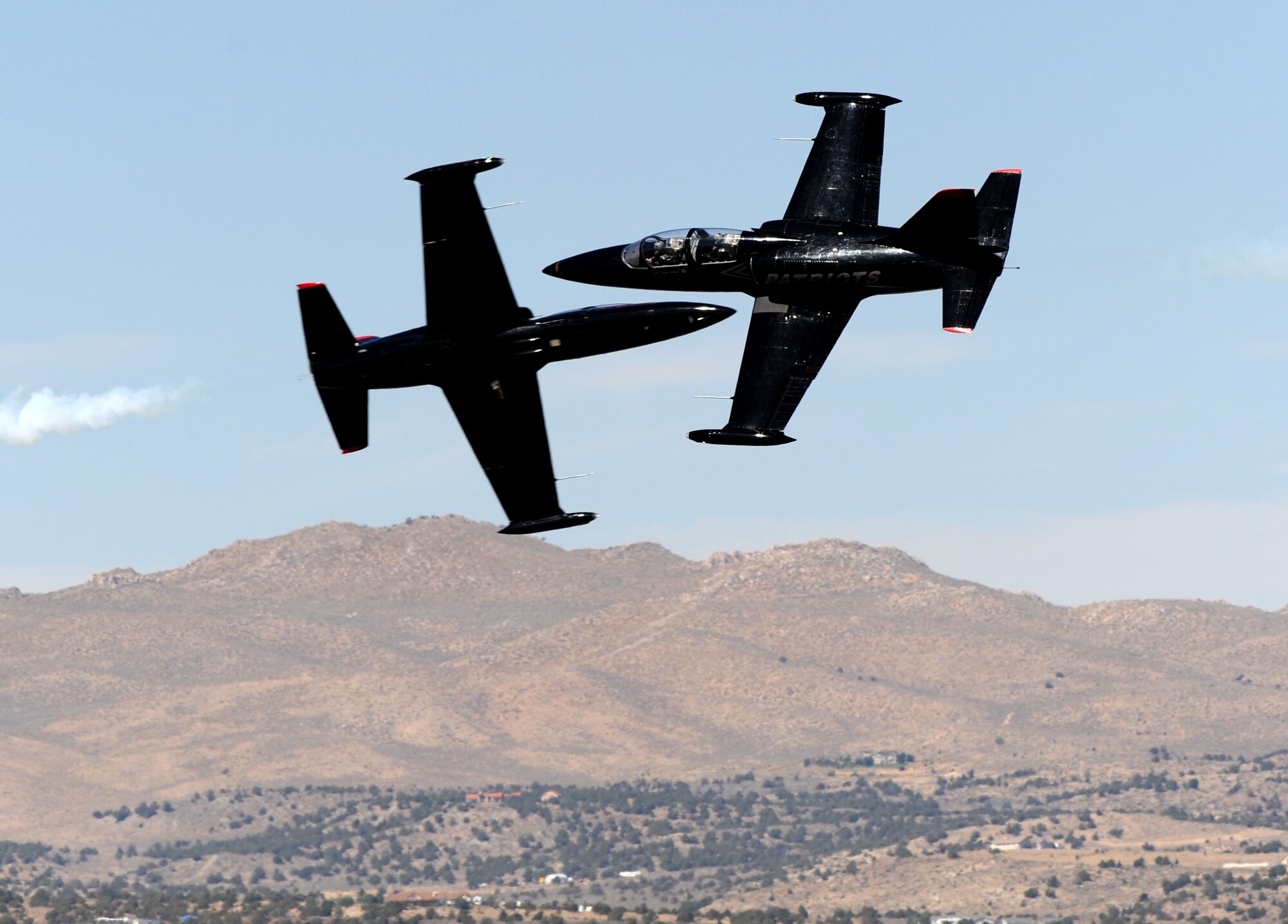 Two L-39 Albatrosses from the Patriots Jet Demonstration Team perform opposing high-speed passes during the National Championship Air Races at Stead Airport, Reno, Nev., Sept. 14, 2012. The Patriots are civilian-owned jet aerobatic team. (U.S. Air Force photo by Staff Sgt. Robert M. Trujillo)